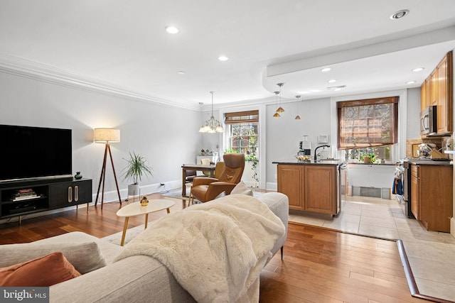 1207 Spruce St Unit 301, Philadelphia, PA 19107 - living room with crown molding, recessed lighting, light wood-style flooring, and baseboards