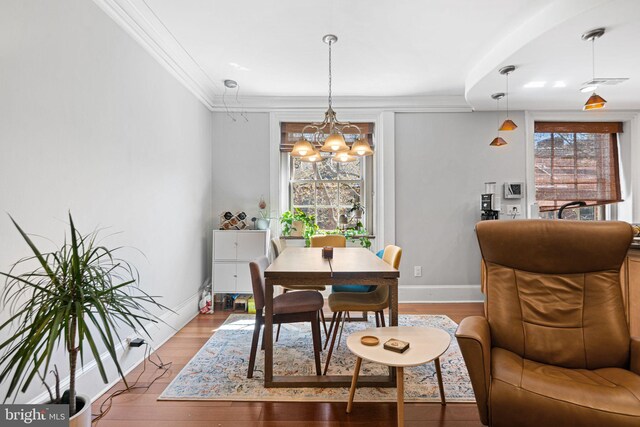 1207 Spruce St Unit 301, Philadelphia, PA 19107 - dining area with crown molding, a notable chandelier, and wood finished floors