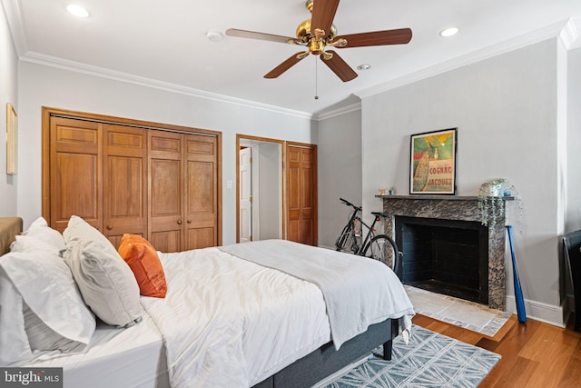 1207 Spruce St Unit 301, Philadelphia, PA 19107 - bedroom with recessed lighting, wood finished floors, multiple closets, a fireplace, and crown molding