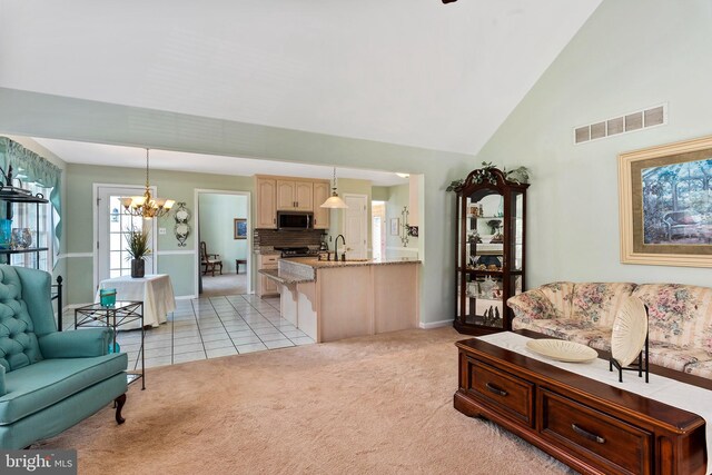178 Cool Breeze Dr, Clayton, DE 19938 - living room featuring light colored carpet, a chandelier, baseboards, light tile patterned floors, and high vaulted ceiling