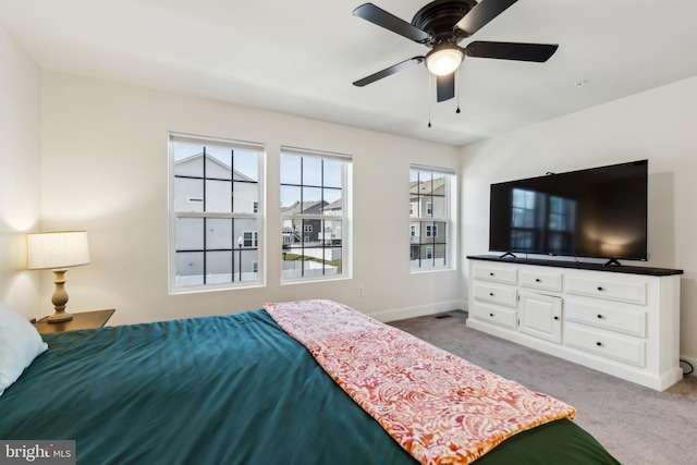 bedroom featuring ceiling fan, baseboards, and carpet