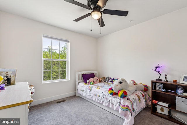 carpeted bedroom featuring visible vents, a ceiling fan, and baseboards