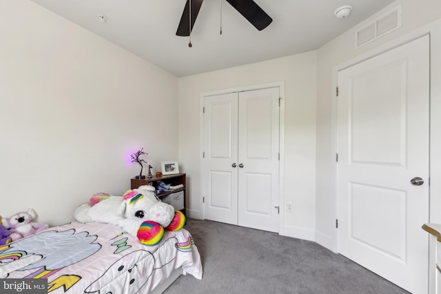 bedroom with a closet, ceiling fan, carpet floors, baseboards, and visible vents