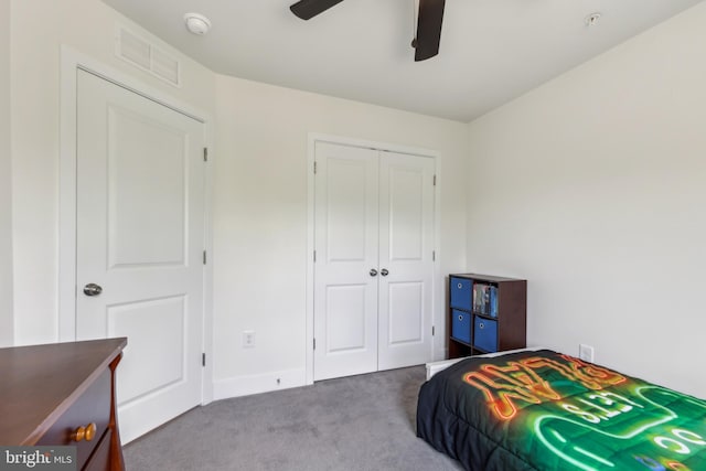 carpeted bedroom with a closet, baseboards, ceiling fan, and visible vents
