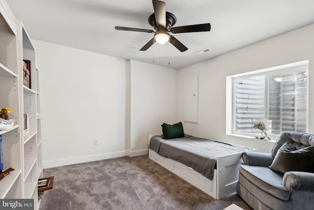 carpeted bedroom with visible vents, a ceiling fan, and baseboards