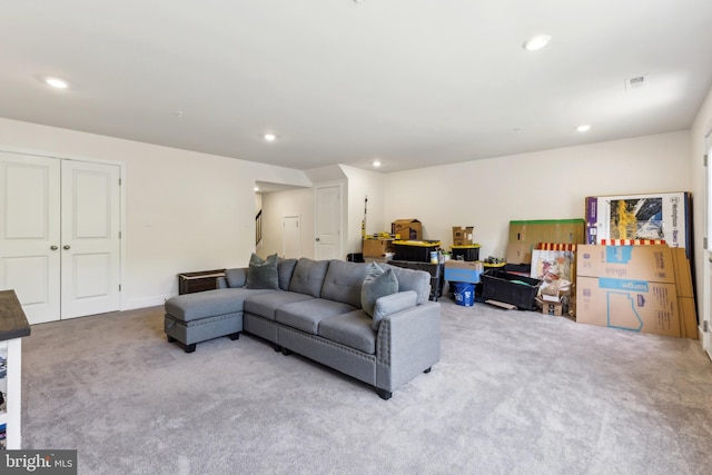 living area featuring carpet floors, visible vents, and recessed lighting