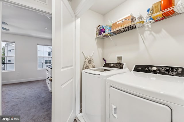 laundry area with baseboards, carpet flooring, washer and dryer, and laundry area