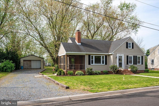 view of front of home featuring roof with shingles, an outdoor structure, a garage, a front yard, and a chimney