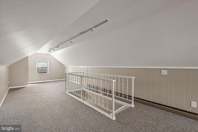 additional living space with vaulted ceiling, carpet, baseboards, and cooling unit