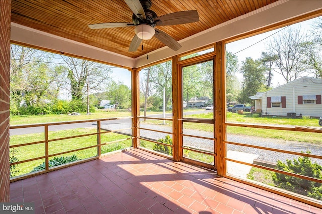 unfurnished sunroom with a ceiling fan