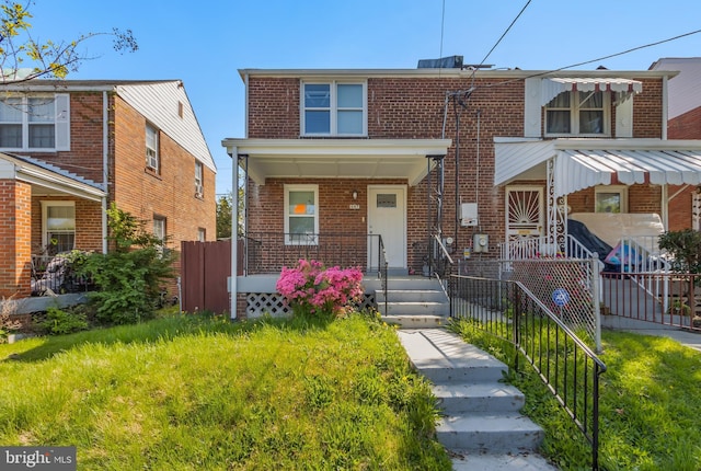 647 Emerson St NE, Washington, DC 20017 - multi unit property with brick siding, covered porch, and fence private yard