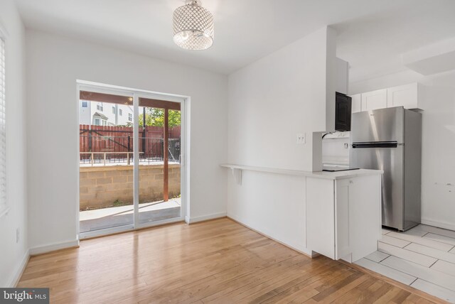 647 Emerson St NE, Washington, DC 20017 - unfurnished dining area with light wood finished floors and baseboards