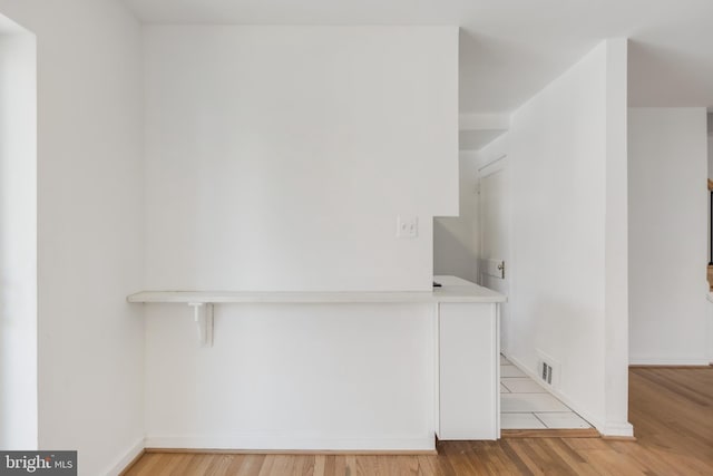 647 Emerson St NE, Washington, DC 20017 - clothes washing area with light wood finished floors, baseboards, and visible vents