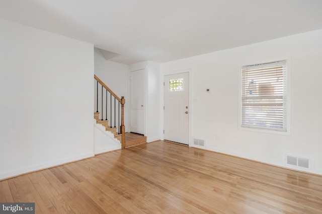 647 Emerson St NE, Washington, DC 20017 - entrance foyer with stairway, baseboards, light wood-style floors, and visible vents