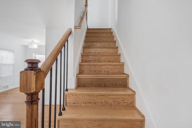 647 Emerson St NE, Washington, DC 20017 - stairway with wood finished floors, visible vents, and baseboards