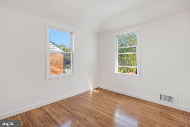 647 Emerson St NE, Washington, DC 20017 - spare room with baseboards, wood finished floors, and visible vents