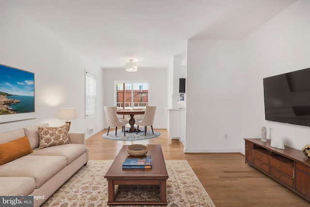 647 Emerson St NE, Washington, DC 20017 - living room with light wood finished floors, baseboards, and visible vents