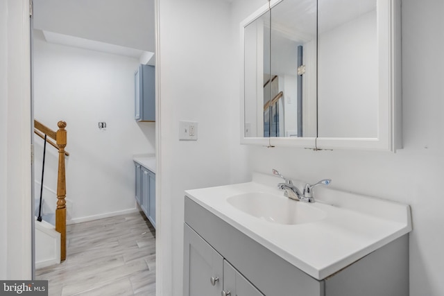 647 Emerson St NE, Washington, DC 20017 - bathroom featuring baseboards, wood finished floors, and vanity
