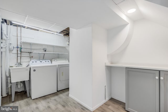 647 Emerson St NE, Washington, DC 20017 - laundry room featuring light wood finished floors, a sink, laundry area, and independent washer and dryer