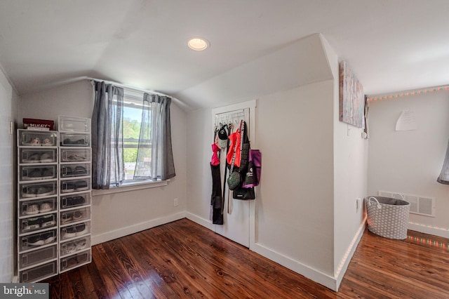 additional living space featuring visible vents, baseboards, wood finished floors, and vaulted ceiling