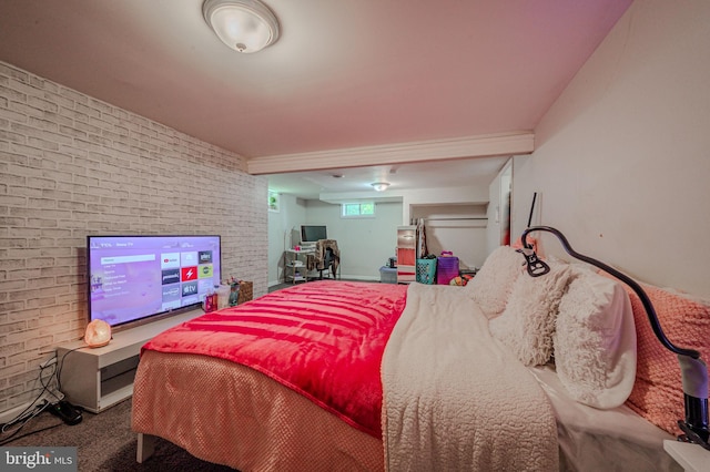 carpeted bedroom with brick wall