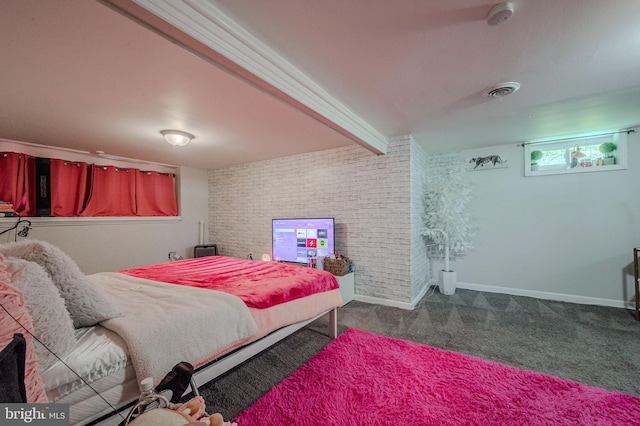 bedroom with baseboards, dark carpet, brick wall, and visible vents