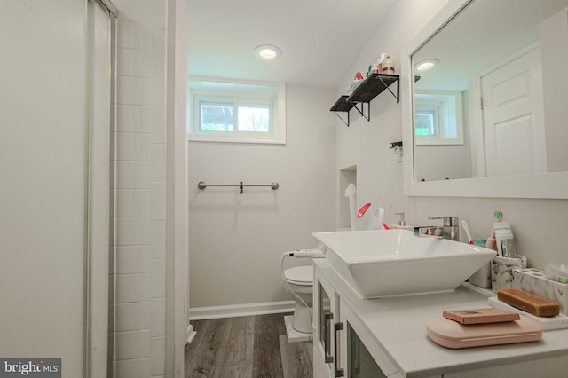bathroom featuring vanity, toilet, recessed lighting, baseboards, and wood finished floors