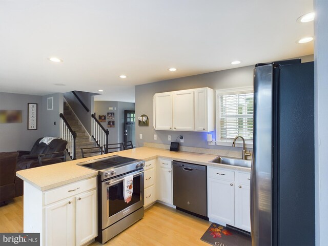10037 Grapevine Rd, Mardela Springs, MD 21837 - kitchen with appliances with stainless steel finishes, a sink, a peninsula, open floor plan, and light countertops