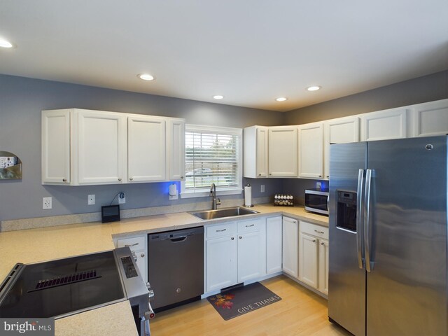 10037 Grapevine Rd, Mardela Springs, MD 21837 - kitchen with stainless steel appliances, a sink, white cabinetry, light countertops, and recessed lighting