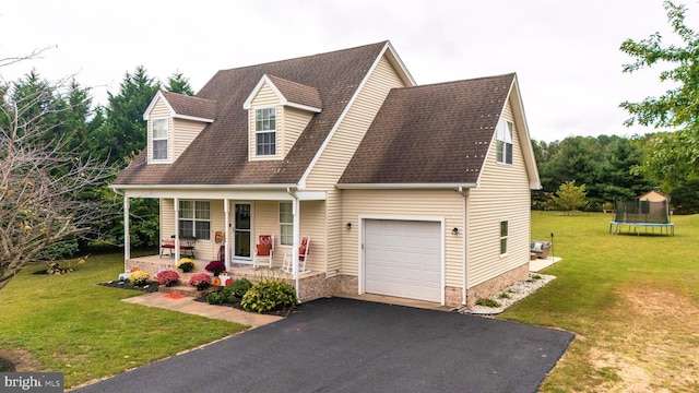 10037 Grapevine Rd, Mardela Springs, MD 21837 - cape cod house featuring covered porch, a trampoline, a front lawn, asphalt driveway, and roof with shingles