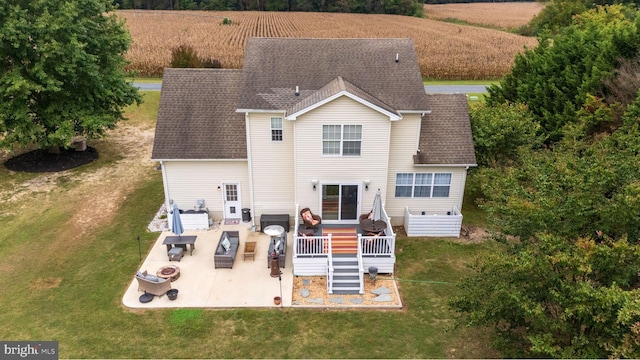 10037 Grapevine Rd, Mardela Springs, MD 21837 - rear view of property featuring a patio, a wooden deck, a yard, outdoor lounge area, and roof with shingles