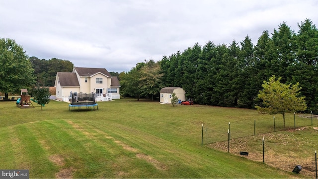 10037 Grapevine Rd, Mardela Springs, MD 21837 - view of yard featuring a storage unit, a trampoline, a playground, and an outbuilding