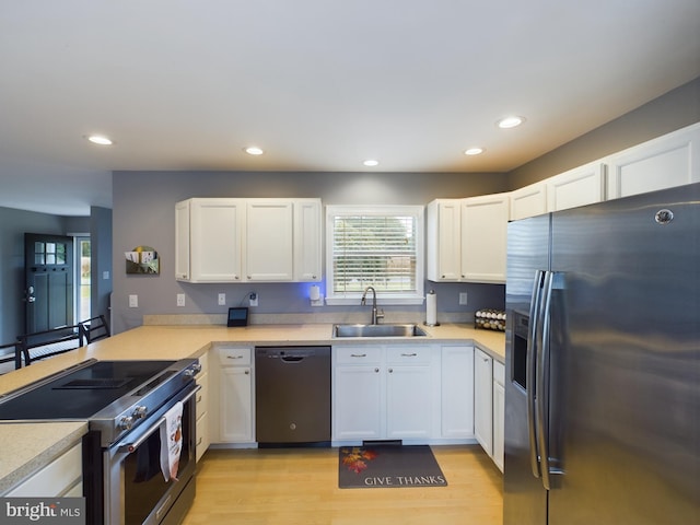 10037 Grapevine Rd, Mardela Springs, MD 21837 - kitchen featuring stainless steel appliances, a sink, light countertops, white cabinets, and recessed lighting