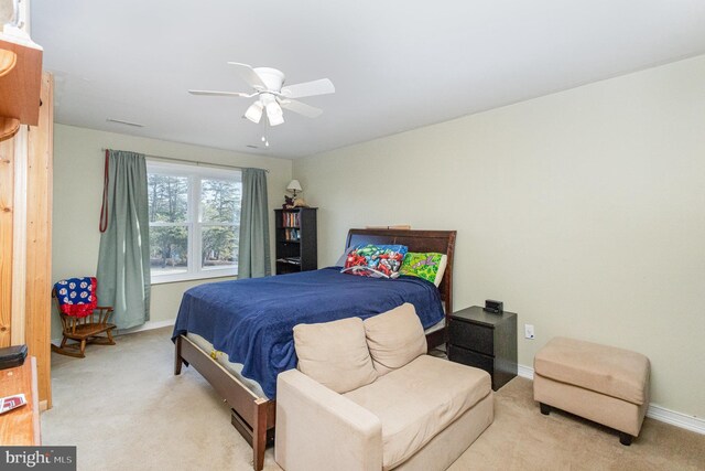 bedroom featuring ceiling fan, baseboards, and light carpet