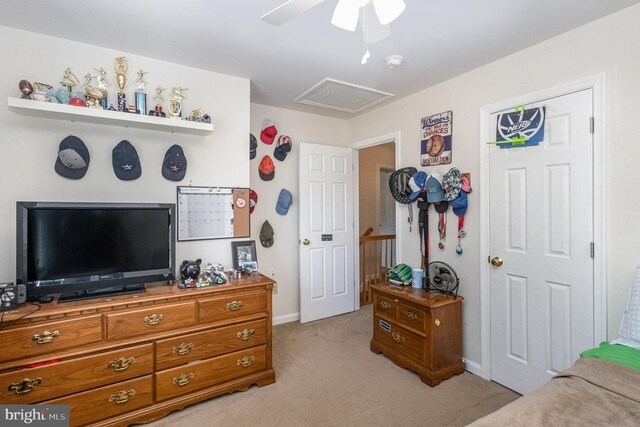bedroom with attic access, ceiling fan, light carpet, and baseboards