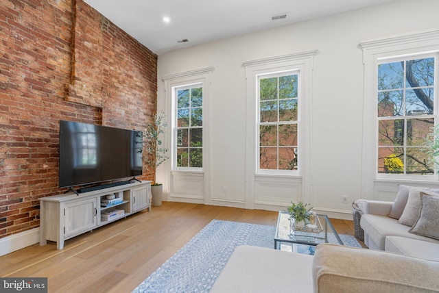 310 Catharine St Unit C, Philadelphia, PA 19147 - living area featuring light wood-style flooring, visible vents, and brick wall