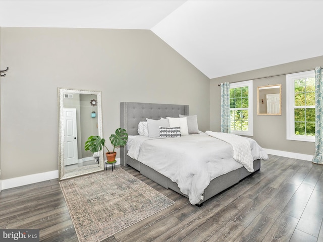 bedroom with lofted ceiling, dark wood-style flooring, multiple windows, and baseboards
