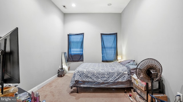 carpeted bedroom featuring visible vents and baseboards