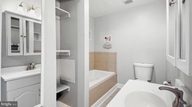 full bath featuring a bath, toilet, baseboards, visible vents, and vanity