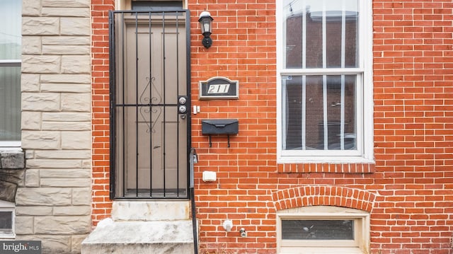 entrance to property with brick siding