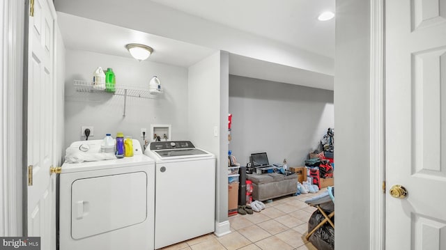 washroom featuring washing machine and clothes dryer, laundry area, and light tile patterned flooring