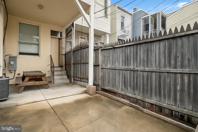 exterior space with fence, cooling unit, and entry steps