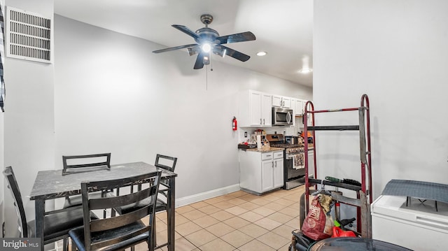 kitchen featuring white cabinets, baseboards, appliances with stainless steel finishes, ceiling fan, and light tile patterned floors