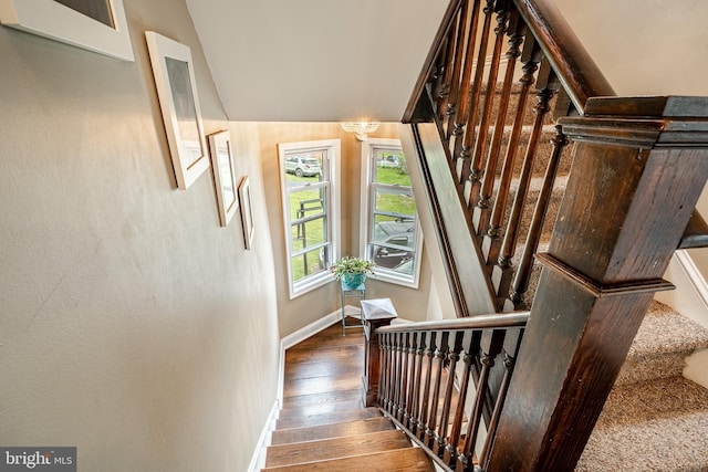 staircase featuring hardwood / wood-style flooring and baseboards