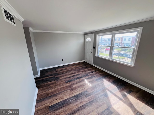 7932 Wynbrook Rd, Baltimore, MD 21224 - unfurnished room featuring baseboards, ornamental molding, dark wood finished floors, and visible vents