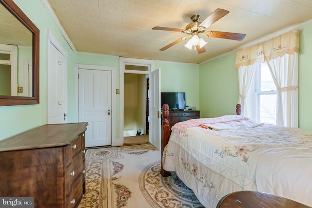 bedroom with crown molding and a ceiling fan