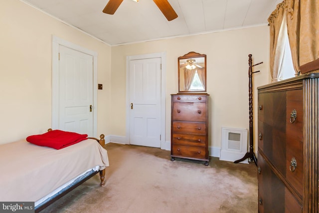 bedroom featuring carpet, crown molding, visible vents, baseboards, and ceiling fan