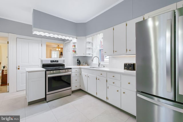 kitchen featuring a sink, stainless steel appliances, open shelves, white cabinetry, and light countertops