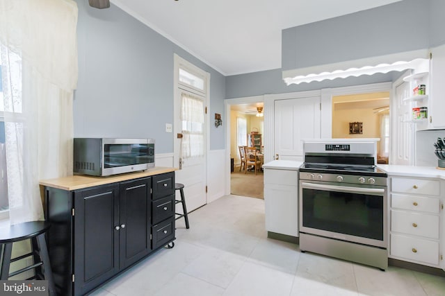 kitchen featuring white cabinets, light countertops, appliances with stainless steel finishes, and ceiling fan