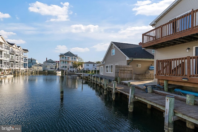 dock area featuring a water view and a residential view